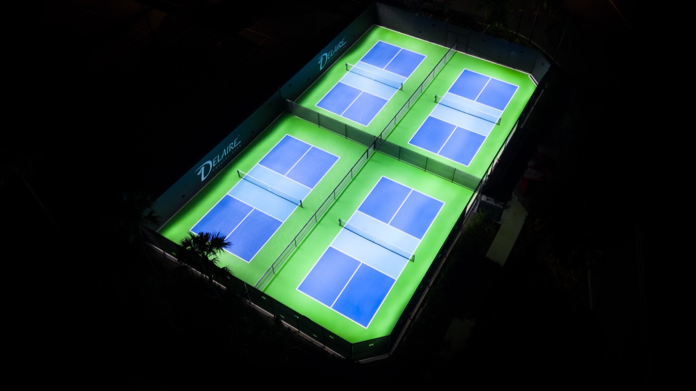 Floodlit courts at Delaire Country Club, Delray Beach, Florida, seen from the air at night